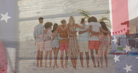 Naklejka premium Standing eight adults linking arms on sand, wearing striped dress, showing flag overlay, cabana
