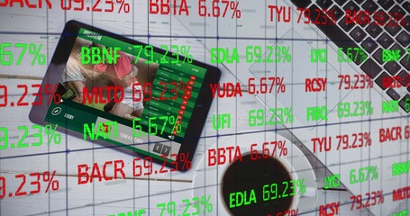 Displaying tablet showing sports broadcast at desk, with laptop, coffee, market tickers, copy space © vectorfusionart