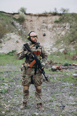 Fototapeta premium Portrait of Ukrainian soldier. A military man during training at a military training ground