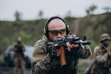 Fototapeta premium A portrait of Ukrainian military man with a rifle