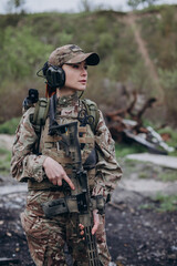 Fototapeta premium Portrait of a female Ukrainian soldier with a rifle