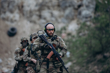 Fototapeta premium Armed Ukrainian patrol practicing at the range