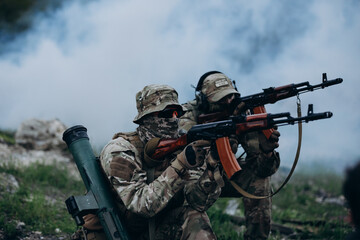 Fototapeta premium A couple of Ukrainian soldiers training with rifles at the range