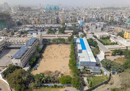 Aerial view of St. Patrick's Cathedral and the surrounding urban landscape with institutional buildings and solar panels in Karachi, Sindh, Pakistan.