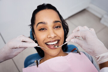 Dentist, portrait and woman in clinic with exam, checkup tools or cavity assessment in oral care. Smile, patient or orthodontist with mouth mirror, tooth health or consultation in dental appointment. © peopleimages.com