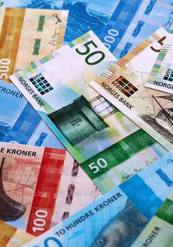 Norwegian krone money bills pile on table. Norway banknotes of NOK currency close up.