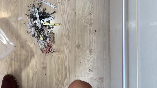 man organizes different things in a box, top view, sound