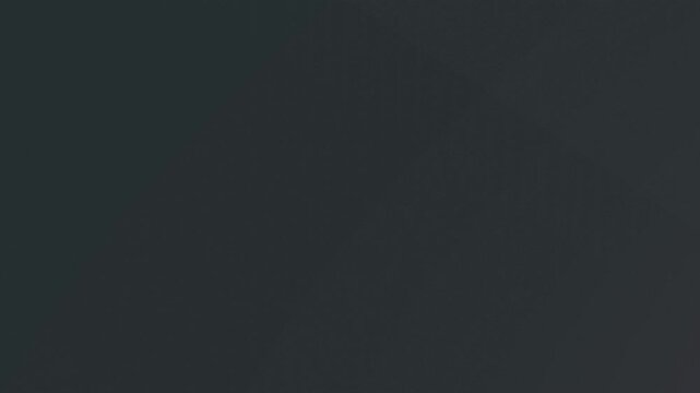 A dark, textured background with a subtle gradient of purple at the bottom