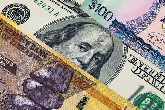Different 100 Dollars banknotes from the USA, Guyana, and Zimbabwe. Global variety of the dollar as a monetary unit.