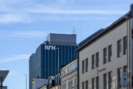 Kristiansand, Norway - 27 March, 2026: Modern NRK S&oslash;rlandet Building Architecture Featuring Sleek Blue Glass Facade and Urban Cityscape Skyline