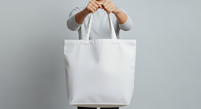 Person is holding a white canvas bag tote bag mockup mockup fabric bag tote blank canvas cloth design eco fashion cotton shopping empty background
