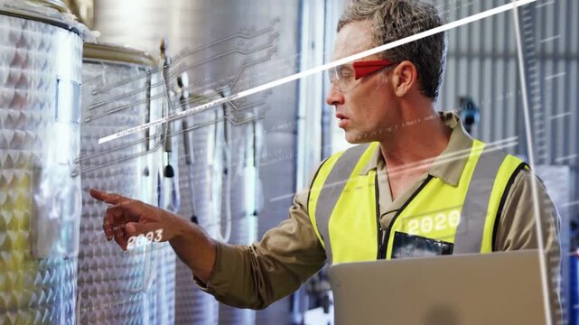 Vertical video: Plant tech touching tank port activating year-data lines while viewing laptop