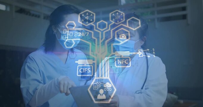 Doctor holding tablet and nurse tapping in hospital initiating HUD with CIFS NFC to review records