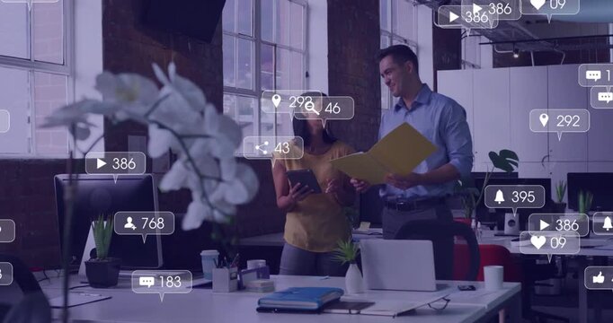 Man opening yellow folder, woman holding tablet by windows, sparking marketing icons hiding, fading