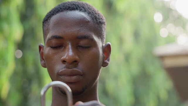 Focused artisan fitting u shaped hardware outdoors, finishing stage of carpentry project with steady hands, beads of sweat and closeup detail of fit and alignment, preparing furniture component