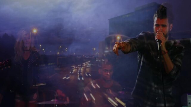 Projected highway cueing music set, lead singer bringing mic and singing as lights overlay band