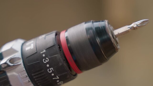 Macro view of chuck setting carpentry showing calibration mood and careful adjustment, emphasis on torque numbers, tightening collar and equipment care on clean workshop bench, technical precision