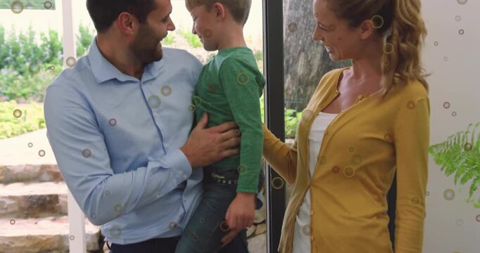 Door opening sparking family arriving, man lifting child, woman resting hand, sharing warm greeting