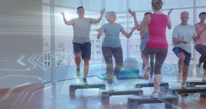 Instructor cueing group stepping on platforms in fitness studio, participants marching for balance