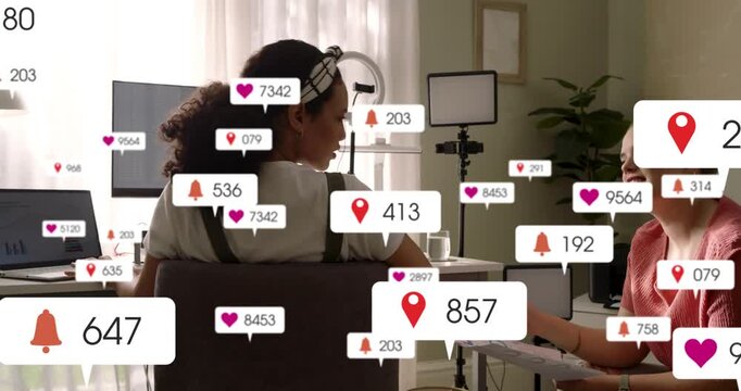 Two women working in studio notification popping and spawning heart pins while growing social reach