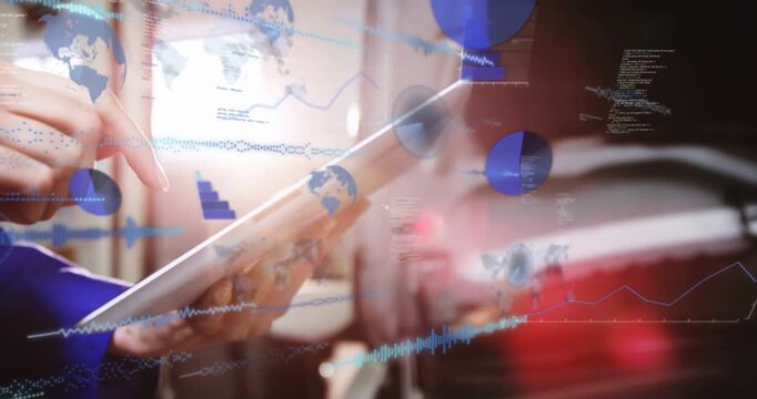 Tech hands tapping tablet top and swiping, causing blue charts overlaying tablet, gear for control
