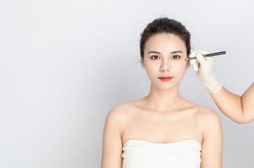 Fototapeta premium Asian Beauty in a White Background with Medical Aesthetics, Cosmetic Surgery, and Beauty Makeup Concepts