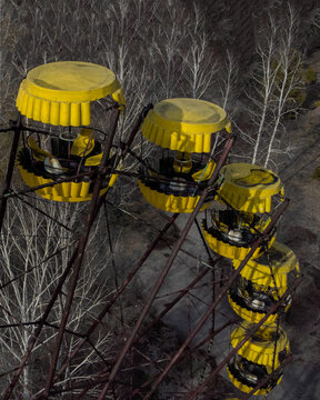 Aerial view of the yellow cabins of the abandoned ferris wheel in the exclusion zone surrounded by leafless trees Pripyat, Kyiv Oblast, Ukraine.