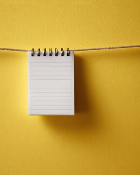 tear off planner notepad hanging on yellow background scheduling reminder concept