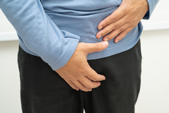 Hernia, Asian man stomach ache, abdominal pain and urology problem health.