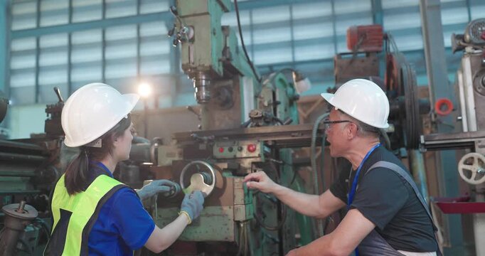Father passes down machine know-how to his daughter in a family factory, guiding succession, workshop skills and leadership transition through hands-on manufacturing training.
