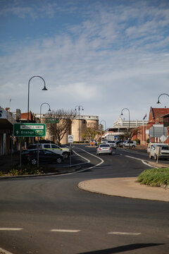 Rural Australian town street scene with Mitchell Highway sign and cars driving