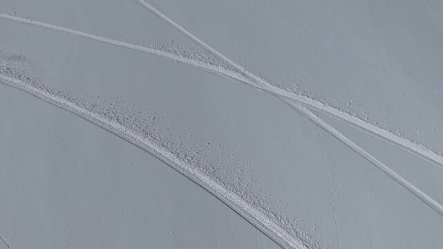 Freeride skiers climbing and descending Bidara peak in Gudauri on deep fresh powder snow, winter adventure in Georgia mountains. Backcountry freeride and skiing untouched powder in snowy mountains.