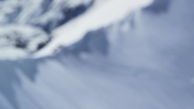 Freeride skiers climbing and descending Bidara peak in Gudauri on deep fresh powder snow, winter adventure in Georgia mountains. Backcountry freeride and skiing untouched powder in snowy mountains.