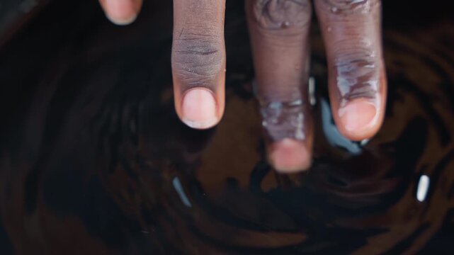 Furniture maker fingers checking varnish finish, closeup of timber grain and wet coating examination, inspection routine in workshop, careful touch and repair cues, quality control moment