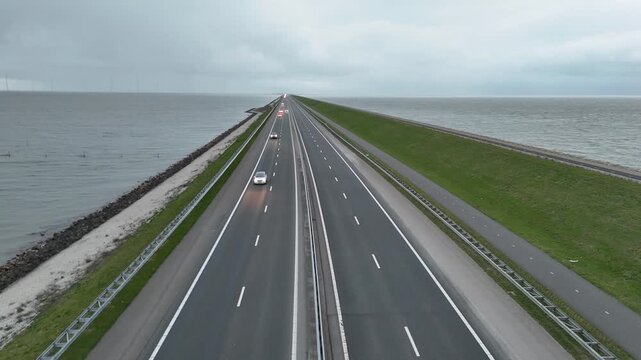 Ascending roadside drone shot along the endless dam