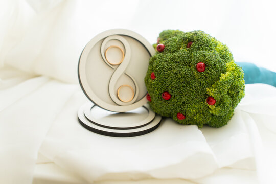 stylish bridal bouquet made of green broccoli and rings