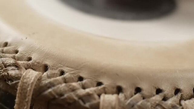 Close-up of a traditional Indian tabla drums intricate lacing and texture.