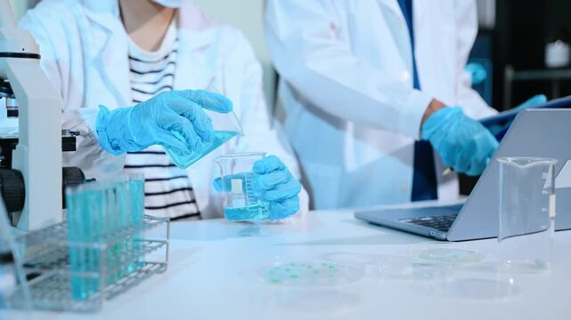 Scientist mixing chemical liquids in the chemistry lab. Researcher working in the chemical laboratory