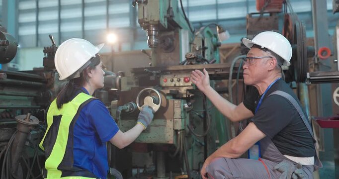 Father passes down machine know-how to his daughter in a family factory, guiding succession, workshop skills and leadership transition through hands-on manufacturing training.
