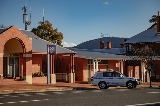 Rural Australian police station with patrol car parked outside on a sunny day