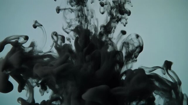 Mesmerizing black ink drop swirling through clear liquid, forming volumetric clouds and smoky trails that create abstract, fluid patterns and dynamic diffusion textures