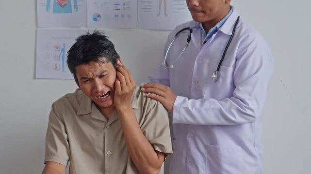 Patient winces in pain as doctor checks ear health during World Hearing Day checkup