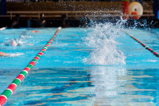 water splash in lane while swimmer is training competitive freestyle