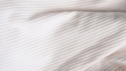 Obraz premium Textured white fabric with subtle ribbed pattern and soft folds