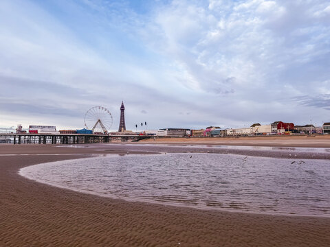 The Blackpool Tower and the pier at night in Blackpool, UK.