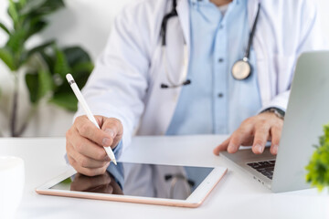 Fototapeta premium Doctor Using Tablet and Stylus for Digital Healthcare Consultation in Modern Clinic