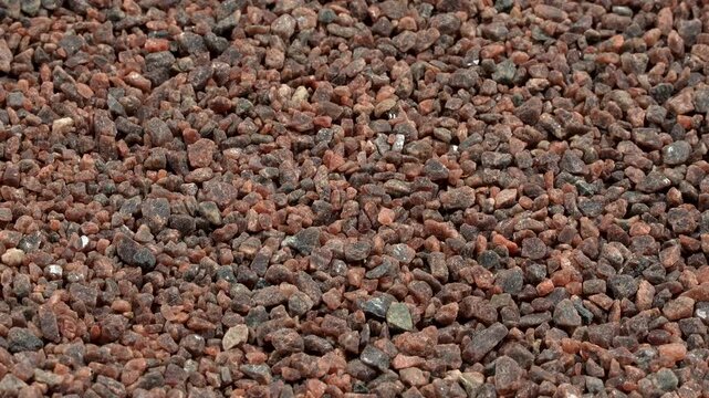 Macro rotating background of coarse Himalayan black salt (Kala Namak). Raw dark mineral texture for vegan culinary and Ayurvedic wellness projects.