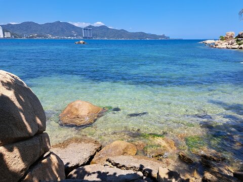 Wide ocean view from Hon Chong in Nha Trang, Vietnam, showing deep blue water, distant islands, and a clear sky. Minimalist seascape with natural light and open space.