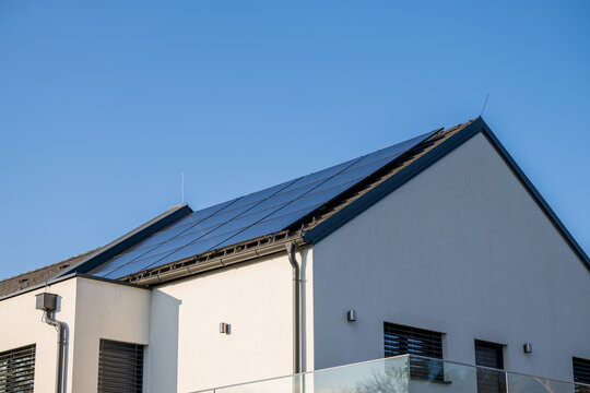 Modern photovoltaic system in black on the roof of a family house