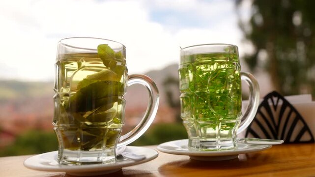 Mate De Coca, Traditional South American Herbal Tea Made From Coca Leaves Served In Glass Mugs. - closeup shot